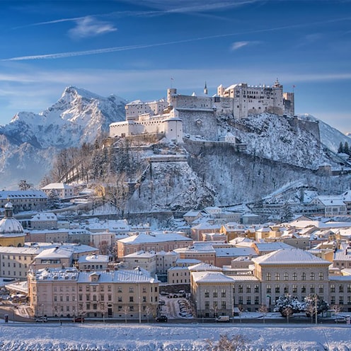 Picturesque Salzburg with snow covering the streets, buildings and surrounding mountains Picturesque Salzburg with snow covering the streets, buildings and surrounding mountains