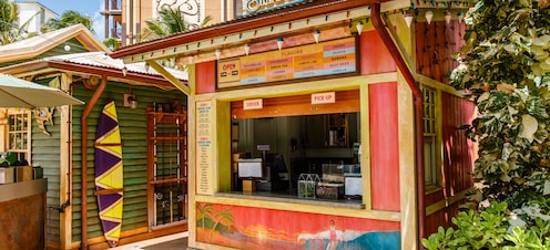 The exterior of Papalua Shave Ice, showing the menu board, ordering instructions and walk-up window