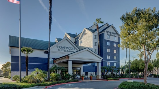 Exterior of Homewood Suites by Hilton Anaheim Main gate Area with a covered entrance and palm trees
