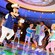 Dressed as a skipper, Mickey Mouse dances with kids on an illuminated dance floor