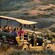 A 12 seat safari jeep filled with passengers driving off road through bush and wilderness