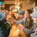 A group of joyful Guests raising their glasses together