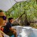 Two people sit in a boat, enjoying the beautiful scenery of the Celestun Wildlife Refuge on their Pink Flamingos Lagoon Boat port adventure