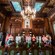 People take photos and look at artwork while walking through a historic room