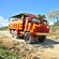 An open air mega truck filled with passengers