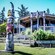 A totem pole standing outside a Native American lodge