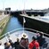 People on the bow of a boat in a canal