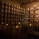 Tealights burning on 6 tables in a room lined from floor to ceiling with wooden wine barrels