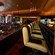 A woman and a man seated next to each other at a bar enjoy the cozy lounge atmosphere