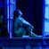 A young girl sits in her open bedroom window at night, imagining the magic of dreams.