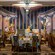 A grand dining room with rose flowers in glass domes, Art Deco columns and a mural with Disney characters
