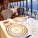 A luxurious dining room with fine table linens, elegant floral and leaf decor and ocean views from every seat