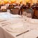 A lavish dining room with chandeliers, chair backs and columns inspired by the Disney film Beauty and the Beast
