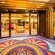 Colorful carpet and a shiny, golden doorway outside White Caps, a store
