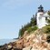 A lighthouse on a cliff overlooking the water