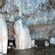 Hundreds of icicle shaped stalactites hang from the ceiling of a cave