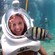 A women smiles as a striped fish swims past her during a Sea Trek Helmet dive