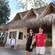 A couple walks through the thatched roof entrance to the Mayan Cacao Company