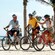3 Guests ride bicycles along an oceanfront path