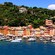 A village built around lush mountains and a marina filled with boats