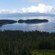 A verdant hillside looks out to an unspoiled cove and islets in the distance