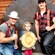 A young child poses with a team of lumberjacks