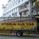 An amphibious truck shaped like a boat has a sign along its side that says Ketchikan Duck Tours