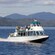 A whale watching vessel is filled with passengers and cruising through the waters of Ketchikan, Alaska