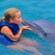 A girl kisses a dolphin