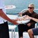 A man hands 2 women and a man drinks