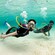 People swimming with SNUBA equipment