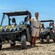 People next to UTV vehicles on rocky terrain