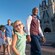 A VIP guide escorts a family of 5 Guests past Cinderella Castle