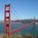 The Golden Gate Bridge with cars on it, stretching across the bay to land on the other side