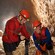 2 people in safety gear in a cave, working with sticks that mark geologic features
