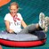 A woman smiles on an inner tube