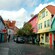 A cobblestone street lined with traditional Norwegian cottage architecture