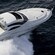 A speeding yacht has hardwood stairs leading to its cabin and tinted windows