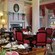 A colonial style living room with 2 huge central columns is set up for afternoon tea