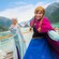 Elsa and Anna from Frozen standing on the deck of a Disney cruise ship
