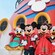 Mickey Mouse, Minnie Mouse, Donald Duck and Daisy Duck dressed in their holiday attire while posing together on a Disney cruise ship 