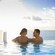 Two Guests relaxing and enjoying the view from an infinity pool on a Disney Cruise Line ship