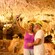 A couple taking a selfie in a cave filled with stalactites, stalagmites and a pool of water