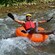 A Guest enjoying a tube ride over rapids in a river