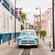 A classic car cruising down a street in Puerto Plata, Dominican Republic