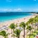 Guests playing in the surf and relaxing on the sand at Isla Verde Beach in Puerto Rico