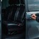 A private driver opening the door of a luxury minivan