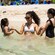 Two little girls and their mother playing in shallow waters at Kuzá Beach and Adventure Park in Cozumel, Mexico