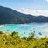 Boats moored in a tropical bay surrounded by hills with lush vegetation