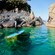 A person on a paddleboard near Cadrega rock in Portofino